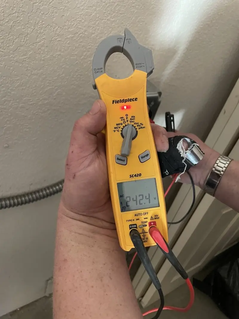 Voltage testing with clamp meter during Electrical Installation Services in Jay